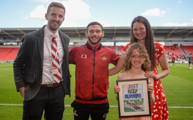 Doncaster half-marathon competition winner presented with framed design by Jon Taylor